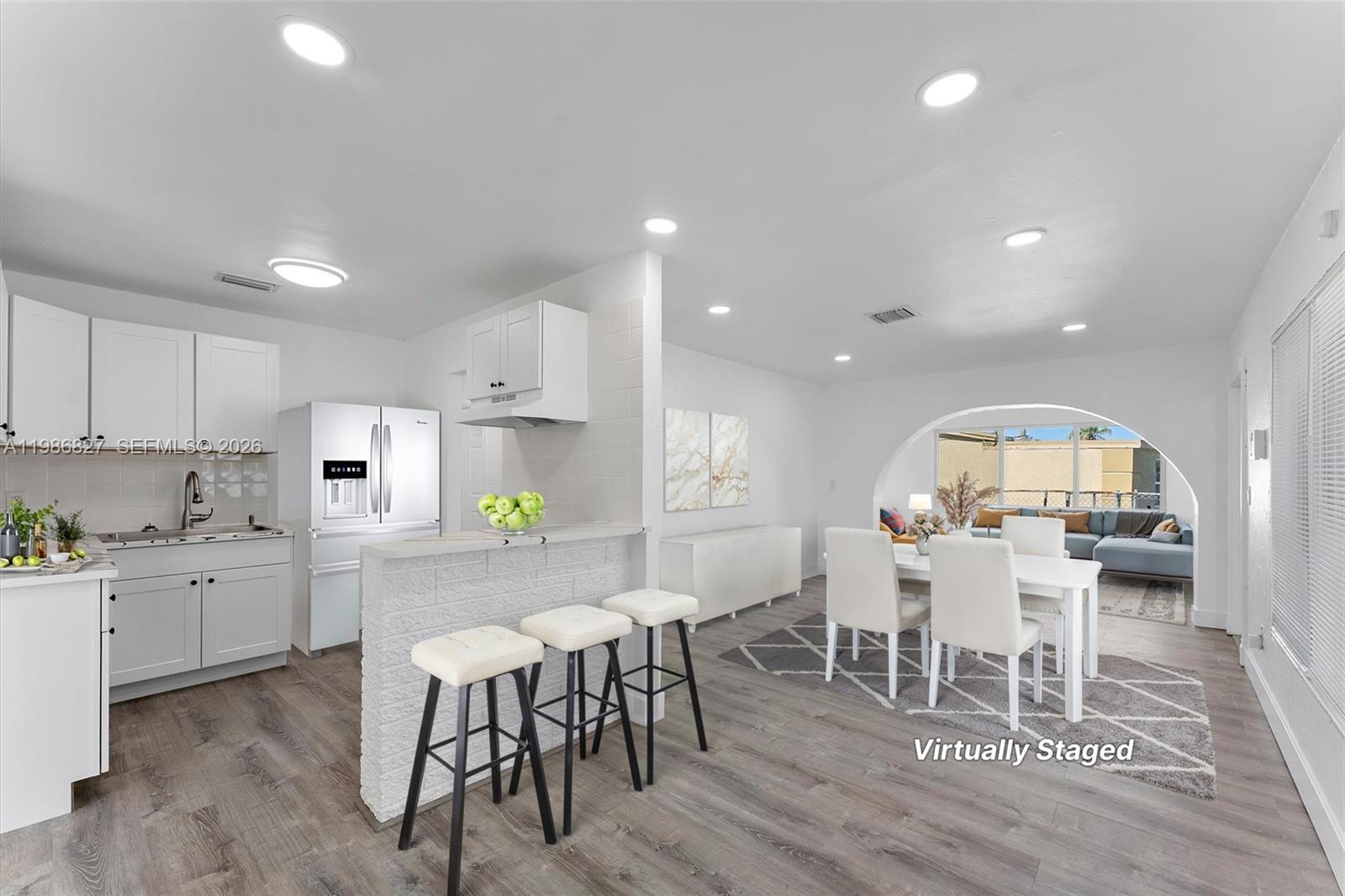 550 Northwest 17th Street Pompano Beach, FL 33060 - Photo 2 of 31 a view of a dining room with furniture and wooden floor