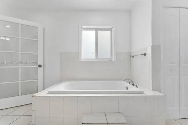 a white bath tub sitting in a bathroom