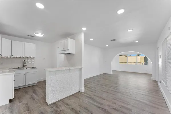 a kitchen with stainless steel appliances granite countertop a stove and a refrigerator