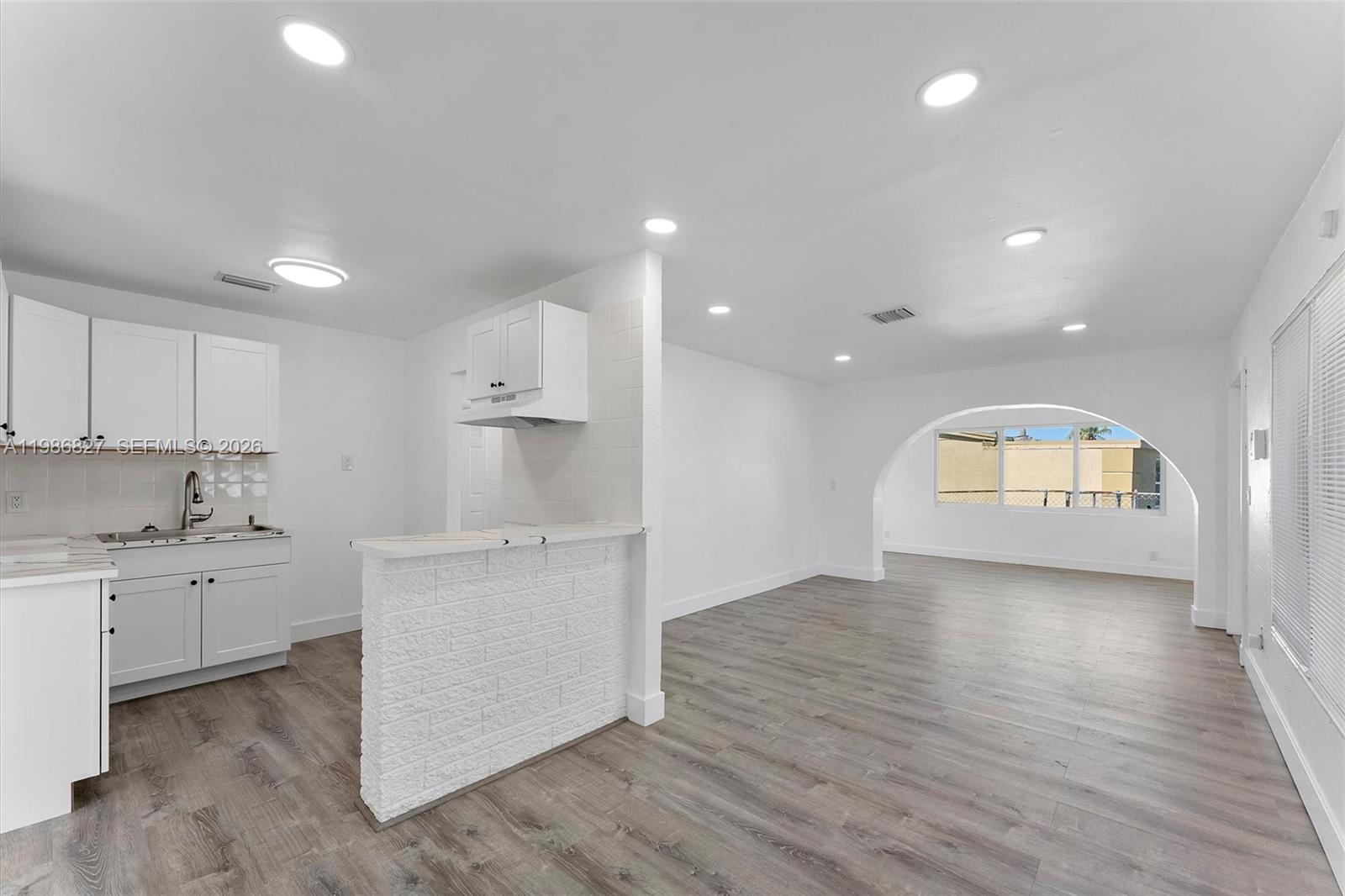 550 Northwest 17th Street Pompano Beach, FL 33060 - Photo 3 of 31 a kitchen with stainless steel appliances granite countertop a stove and a refrigerator