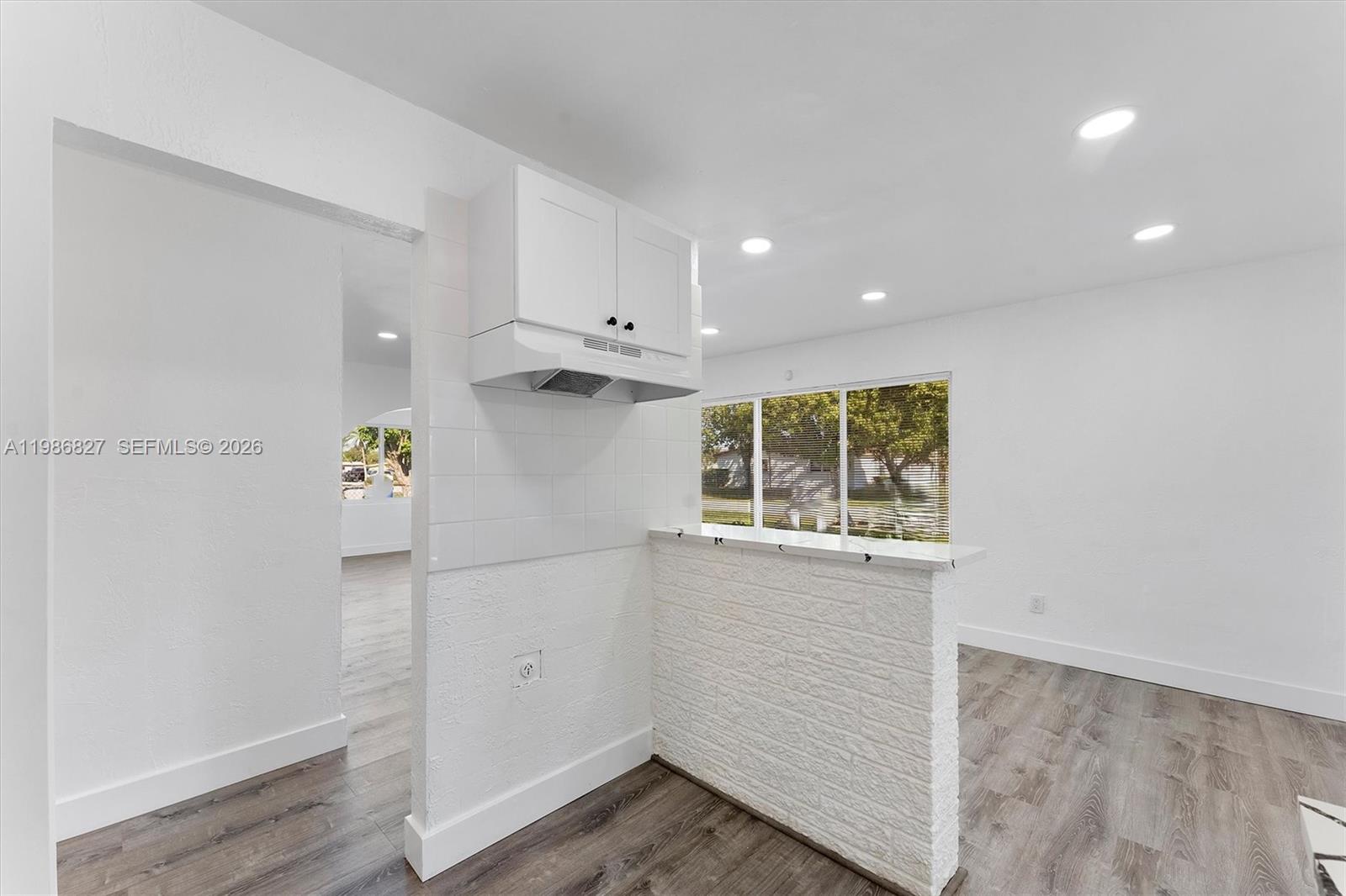 550 Northwest 17th Street Pompano Beach, FL 33060 - Photo 6 of 31 a view of kitchen with wooden floor and window
