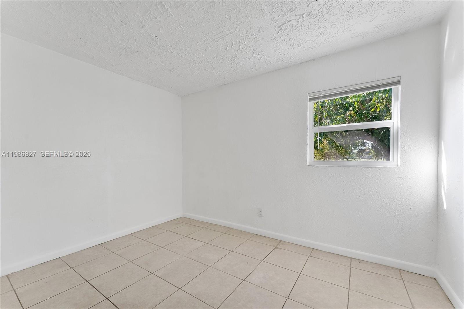 550 Northwest 17th Street Pompano Beach, FL 33060 - Photo 7 of 31 an empty room with a window