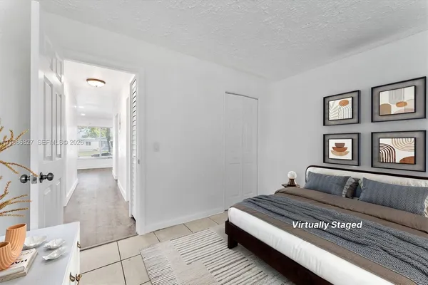 a bedroom with a bed and window