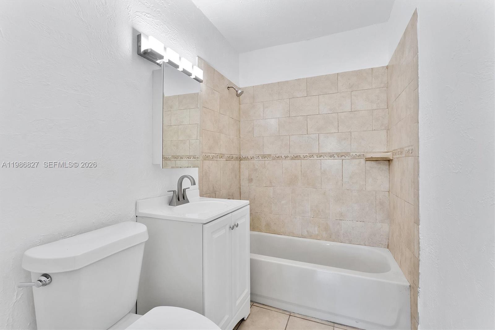 550 Northwest 17th Street Pompano Beach, FL 33060 - Photo 10 of 31 a bathroom with a sink a toilet and shower