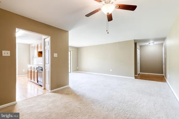 a view of an empty room with a ceiling fan