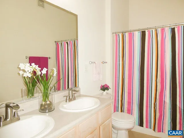 a bathroom with a bathtub sink and a mirror