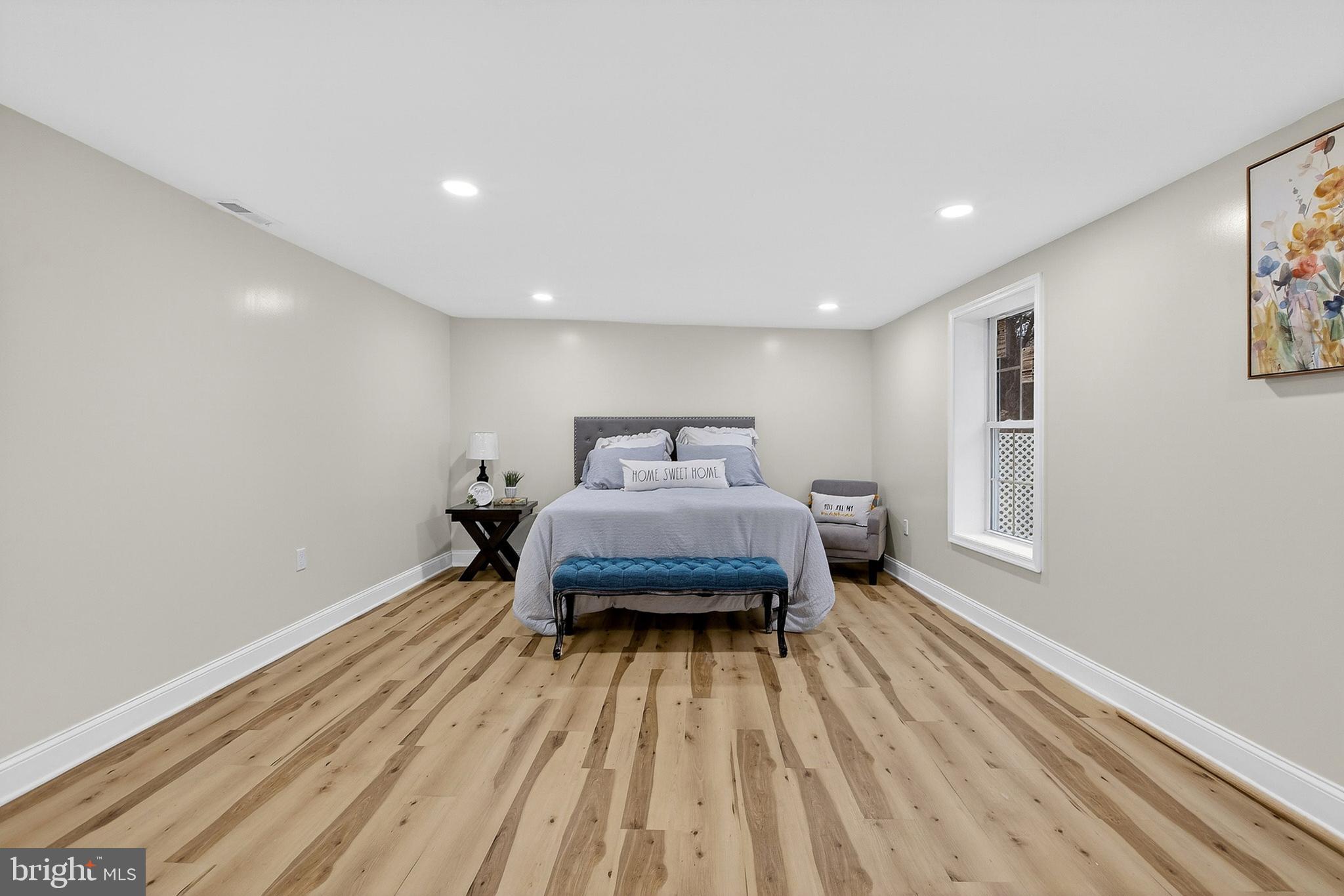 4 Lower Greenbriar Road Wilmington, DE 19810 - Photo 13 of 31 a spacious bedroom with a bed and wooden floor