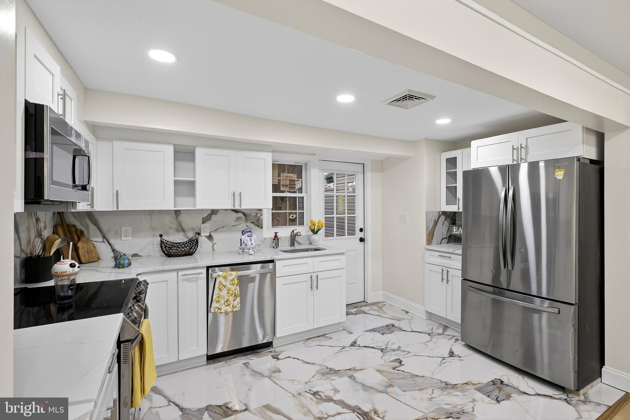 4 Lower Greenbriar Road Wilmington, DE 19810 - Photo 24 of 31 a kitchen with stainless steel appliances granite countertop a stove a refrigerator and a sink