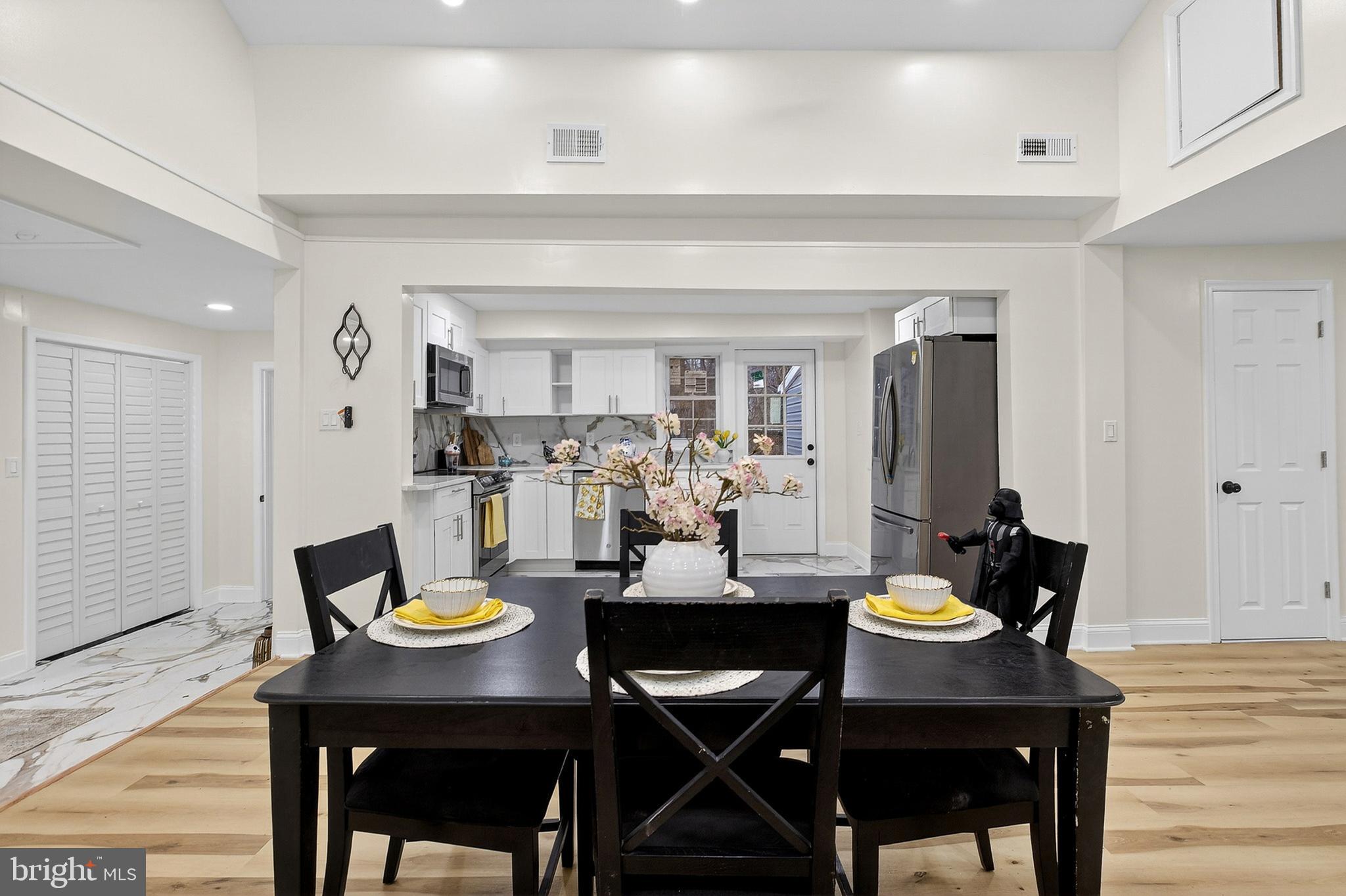 4 Lower Greenbriar Road Wilmington, DE 19810 - Photo 9 of 31 a view of a dining room and livingroom with furniture and wooden floor