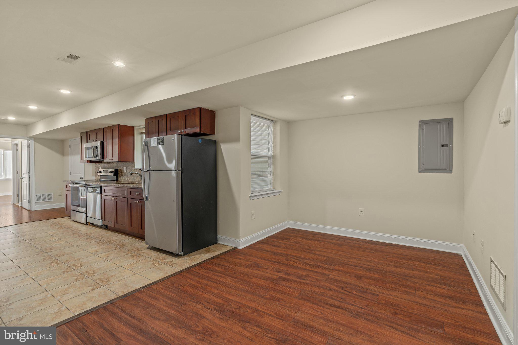 1724 Master Street, Unit C Philadelphia, PA 19121 - Photo 16 of 26 a view of kitchen with refrigerator microwave and wooden floor