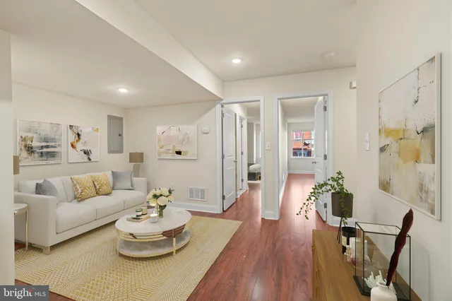 a living room with furniture and wooden floor