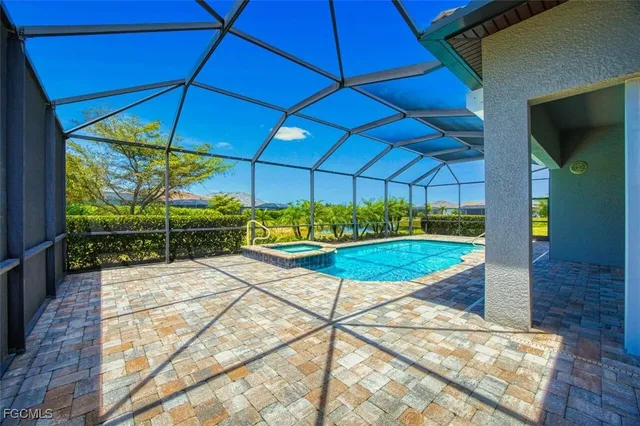 a front view of a house with a yard and potted plants