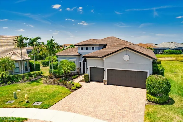 a aerial view of a house with a yard and outdoor seating