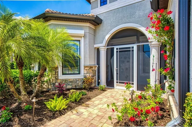 a living room with a flat screen tv and a ceiling fan
