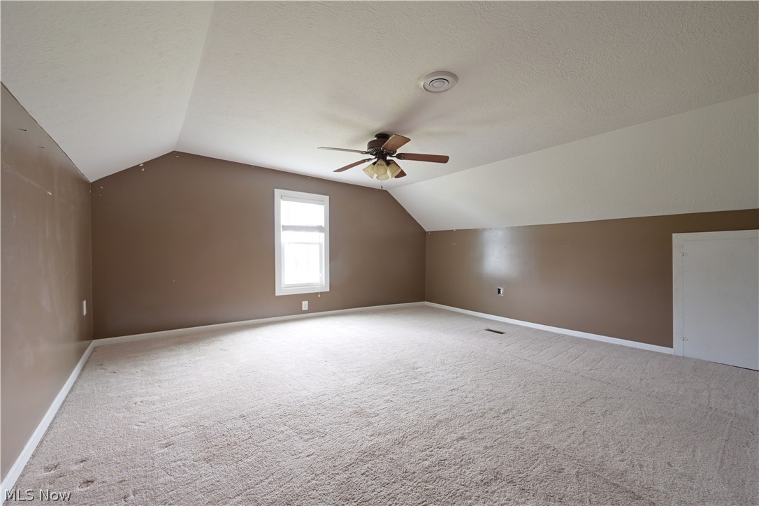 19105 Whitehead Road Lagrange, OH 44050 - Photo 34 of 37 Additional living space featuring carpet floors, lofted ceiling, and ceiling fan