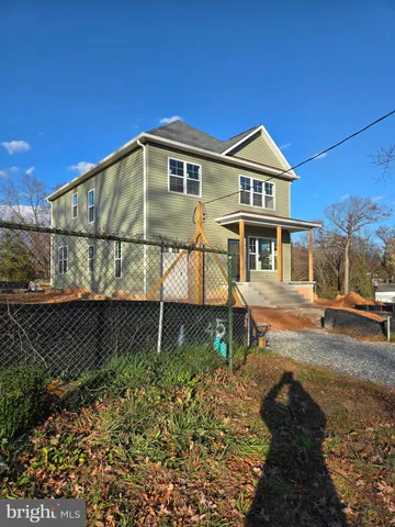 a view of a yard with wooden fence