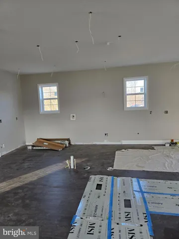 a view of a room with wooden floor and window