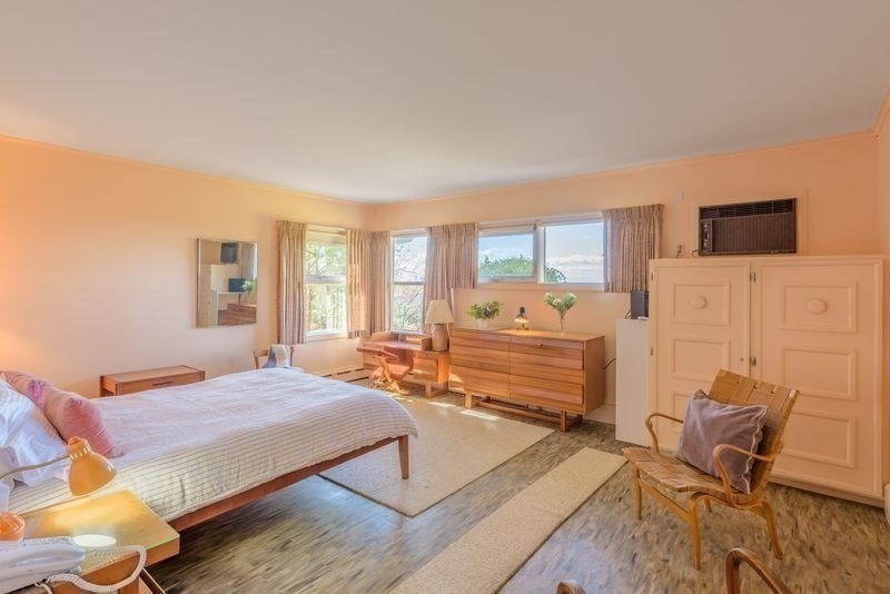 41 Arnold Road Pelham, MA 01002 - Photo 15 of 42 a bedroom with a bed and wooden floor