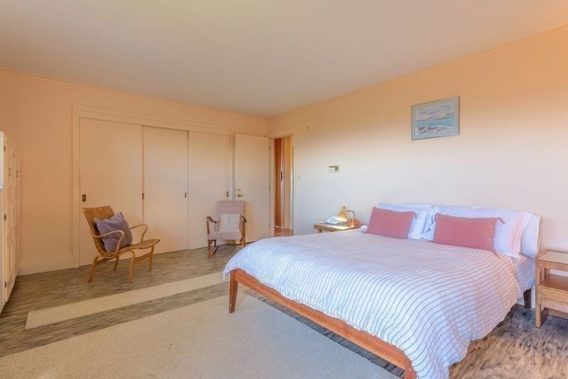 41 Arnold Road Pelham, MA 01002 - Photo 16 of 42 a bedroom with a bed a chair and the dresser next to a window