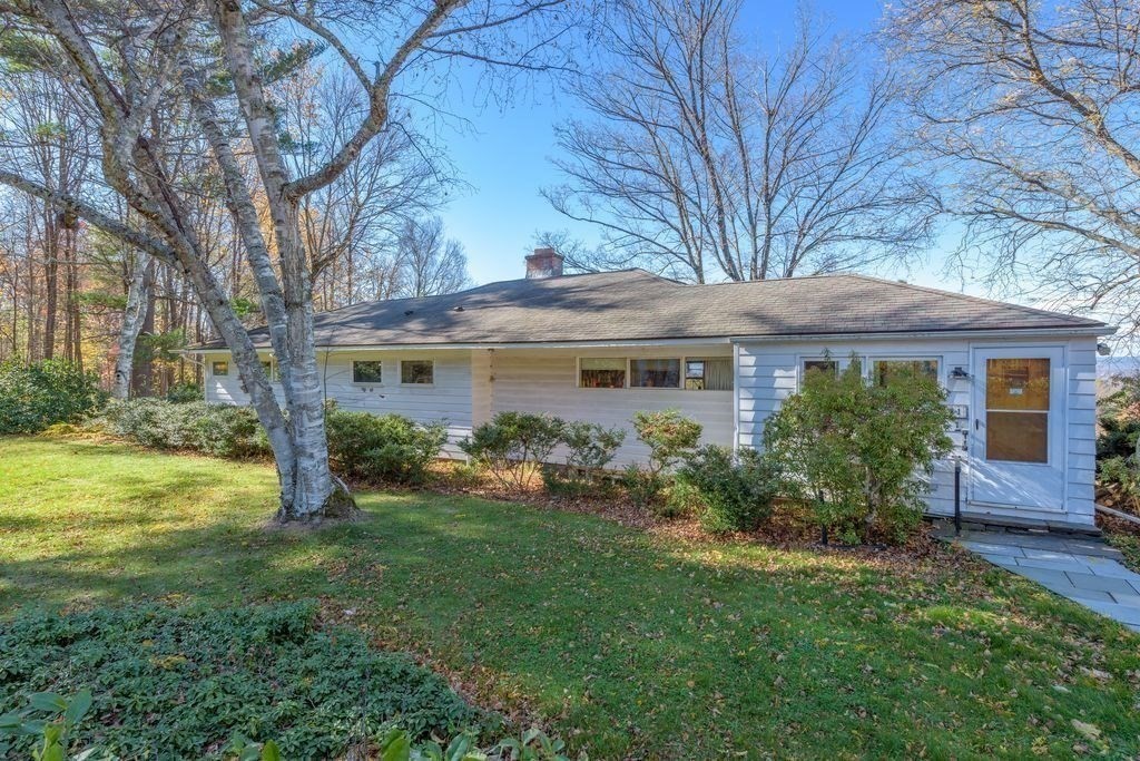 41 Arnold Road Pelham, MA 01002 - Photo 2 of 42 a front view of a house with garden