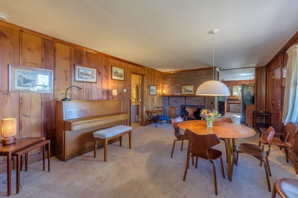 41 Arnold Road Pelham, MA 01002 - Photo 24 of 42 a dining room with furniture and a chandelier