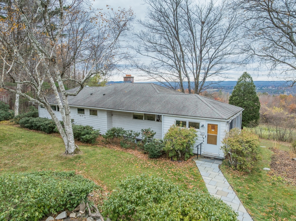41 Arnold Road Pelham, MA 01002 - Photo 41 of 42 a front view of a house with garden