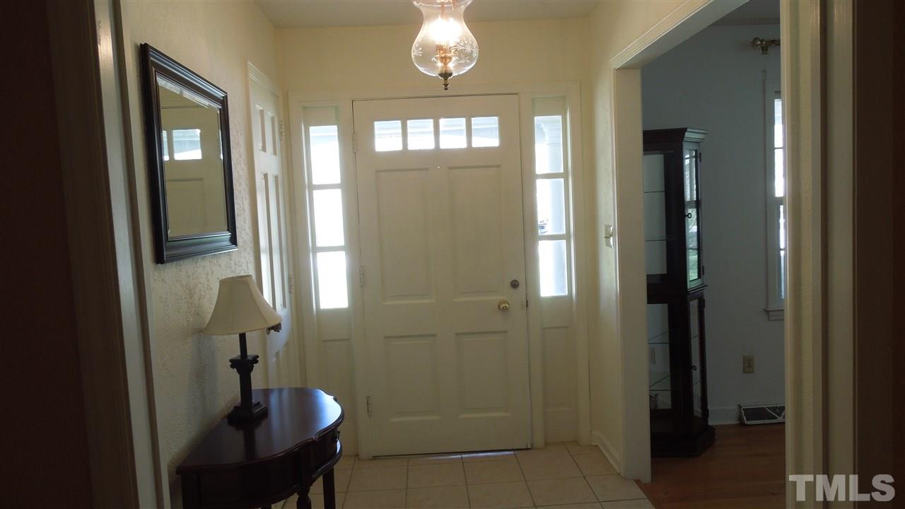 4901 Winterlochen Road Raleigh, NC 27603 - Photo 3 of 25 a bathroom with a mirror a shower and a sink