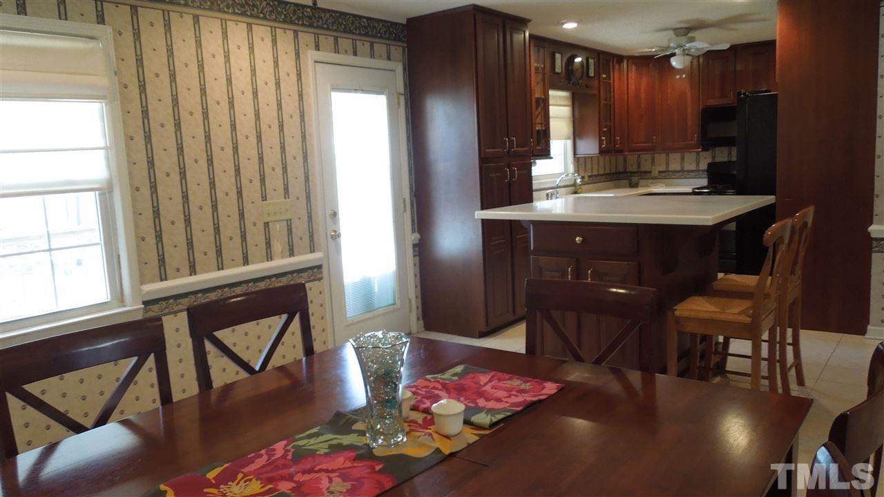 4901 Winterlochen Road Raleigh, NC 27603 - Photo 8 of 25 a view of kitchen with furniture and a potted plant