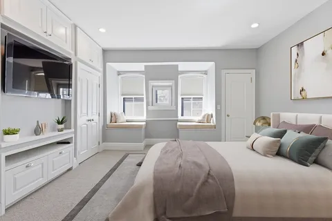 a bedroom with a large bed and a tv