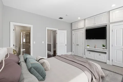 a bedroom with a bed and a flat screen tv