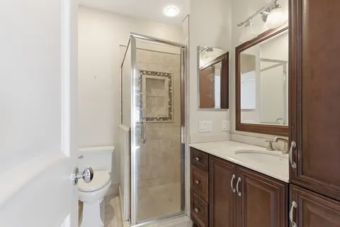 a bathroom with a shower sink and mirror