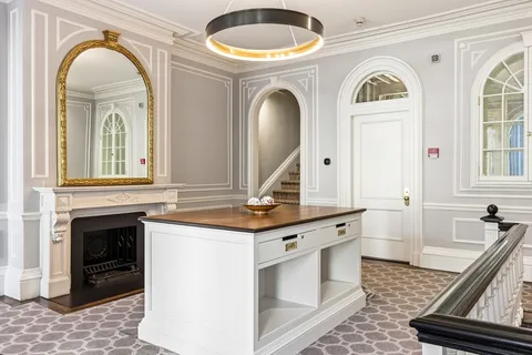 a living room with fireplace furniture and a window