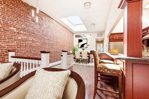 a view of a dining room with furniture and a window