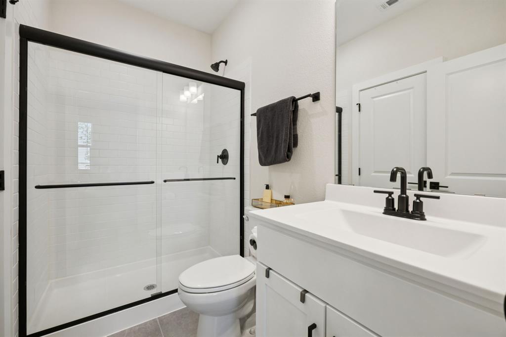 1415 Potenza Road Fate, TX 75087 - Photo 12 of 29 a bathroom with a sink toilet and shower