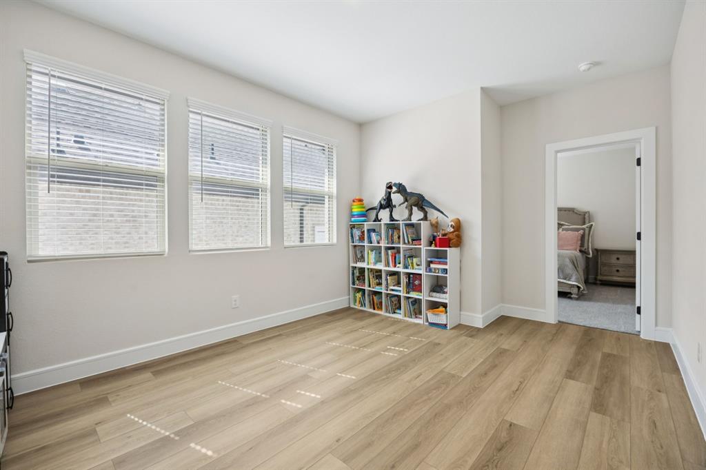 1415 Potenza Road Fate, TX 75087 - Photo 17 of 29 a view of empty room with wooden floor and cabinet