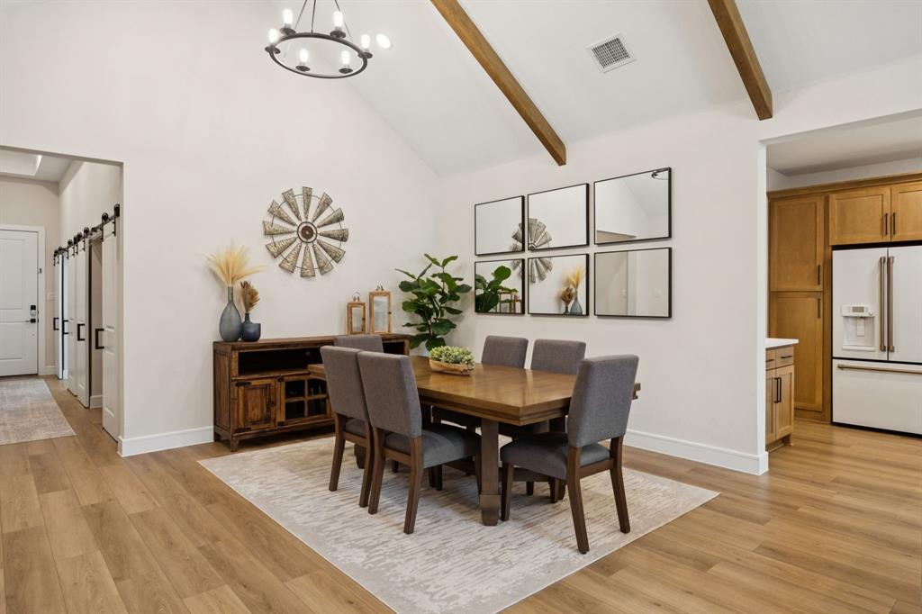 1415 Potenza Road Fate, TX 75087 - Photo 20 of 29 a view of a dining room with furniture and wooden floor