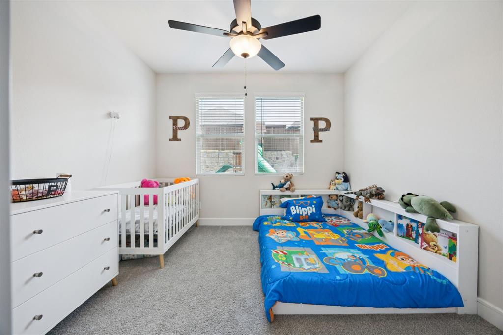 1415 Potenza Road Fate, TX 75087 - Photo 23 of 29 a bedroom with a bed and a dresser