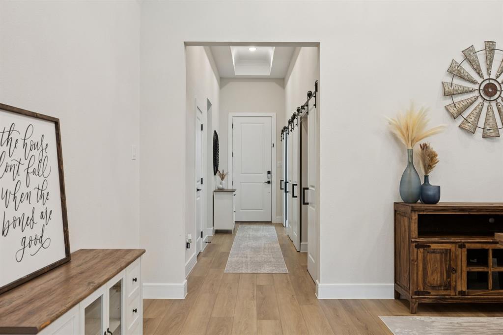 1415 Potenza Road Fate, TX 75087 - Photo 5 of 29 a view of a hallway with wooden floor and workspace