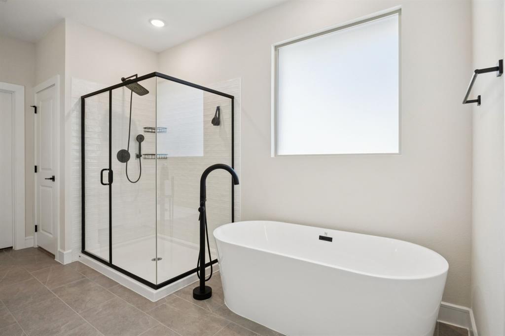 1415 Potenza Road Fate, TX 75087 - Photo 9 of 29 a white bath tub sitting next to a shower