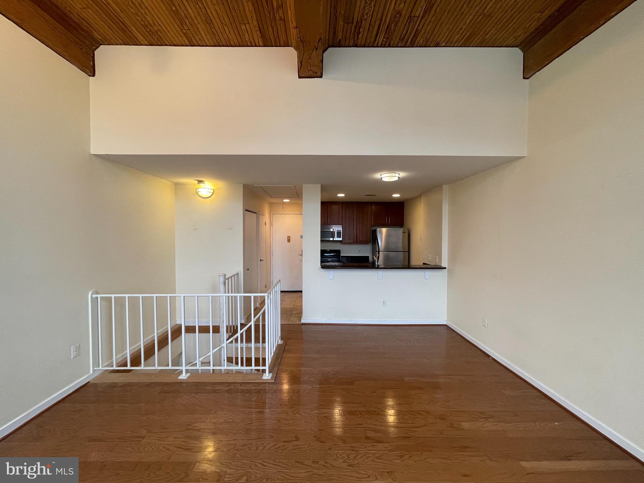 2639 Boston Street, Unit 102 Baltimore, MD 21224 - Photo 1 of 6 a view of a hallway with wooden floor