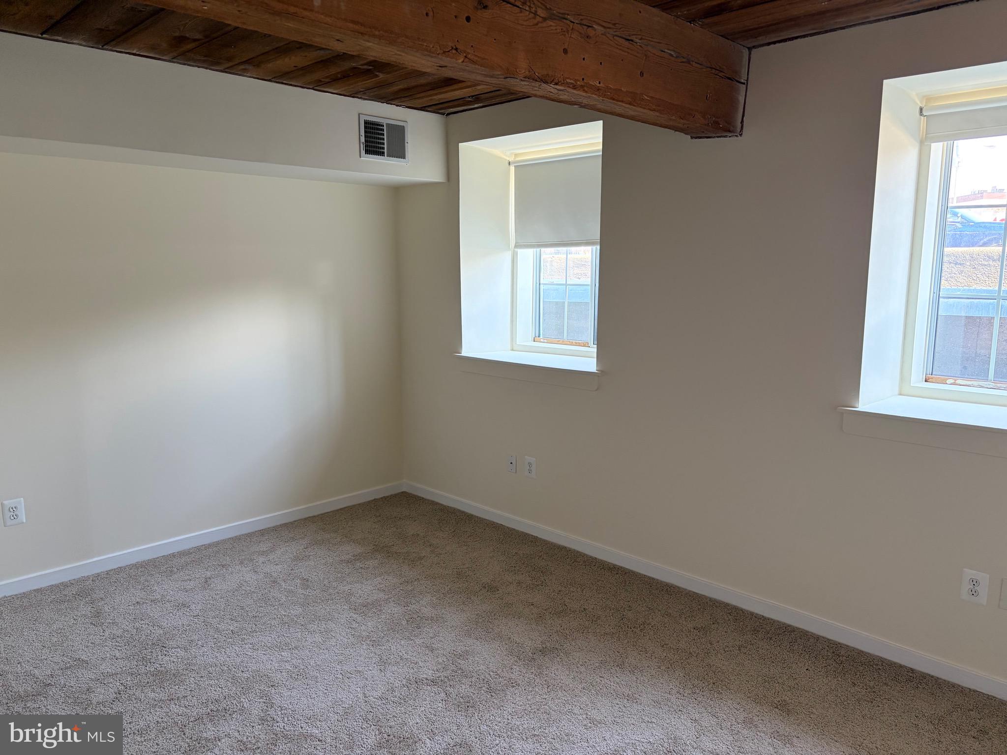 2639 Boston Street, Unit 102 Baltimore, MD 21224 - Photo 4 of 6 an empty room with windows