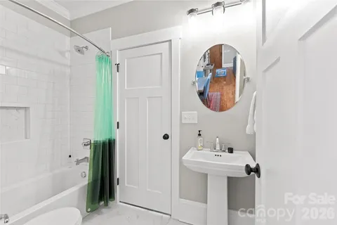 a bathroom with a sink mirror toilet and bathtub