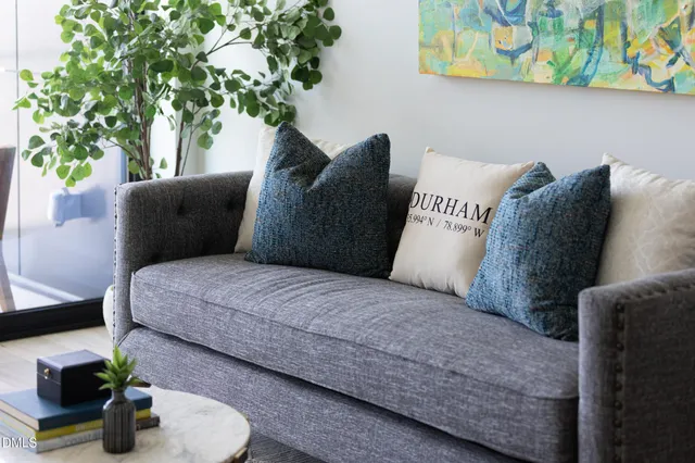a living room with furniture and a potted plant