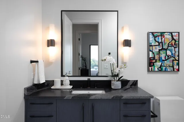 a vase of flowers sitting on a table in a bedroom