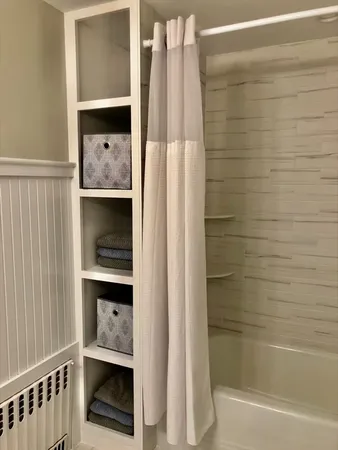 a bathroom with a bathtub and shower