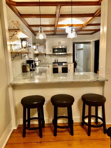 a dining area with chairs and window