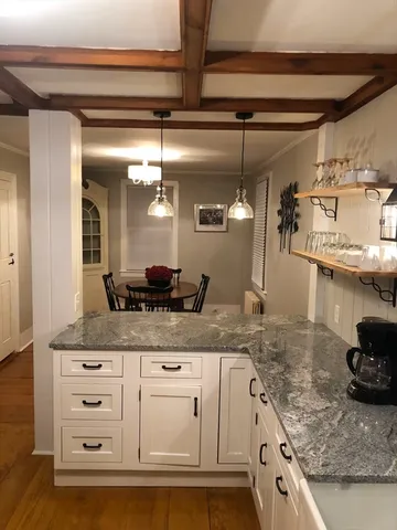 a kitchen with stainless steel appliances granite countertop a sink and cabinets