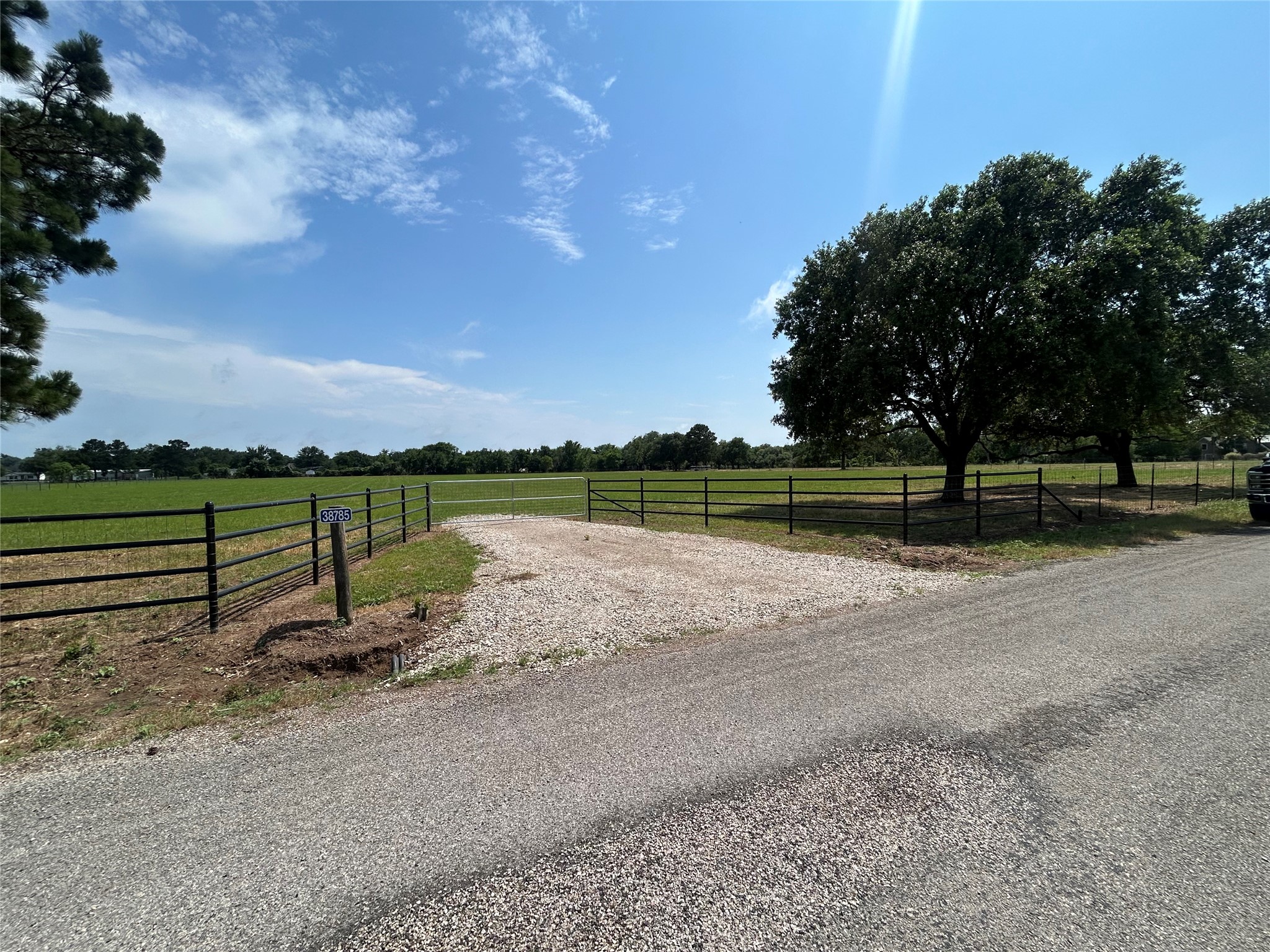 38785 Wiggins Road Hempstead, TX 77445 - Photo 13 of 28 a view of a lake with a big yard and large trees