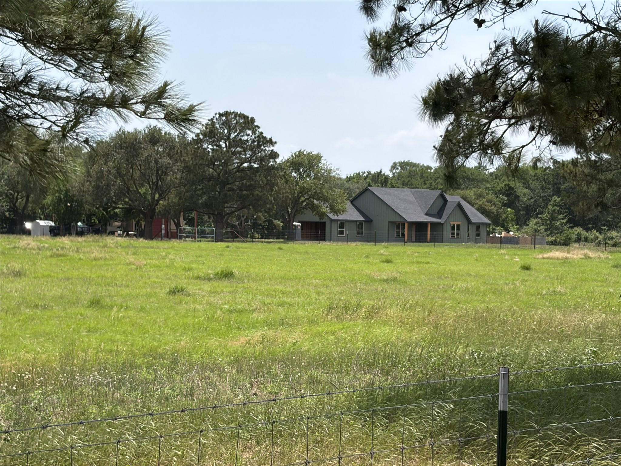38785 Wiggins Road Hempstead, TX 77445 - Photo 19 of 28 a view of a green field with trees in the background