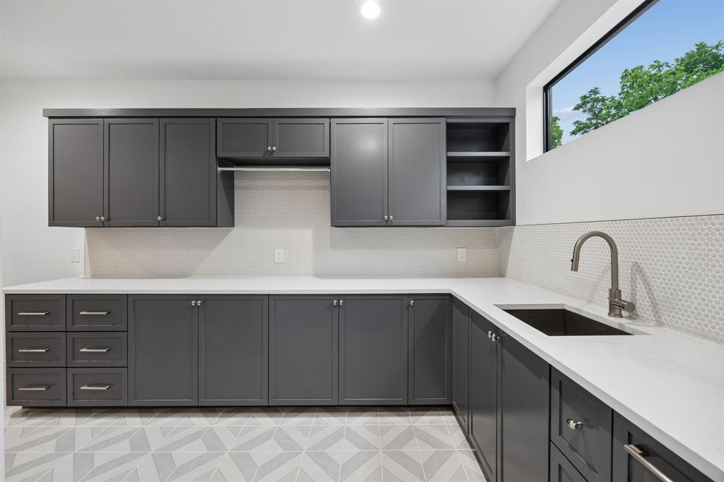 4311 Merrell Road Dallas, TX 75229 - Photo 27 of 30 a kitchen with a sink and cabinets